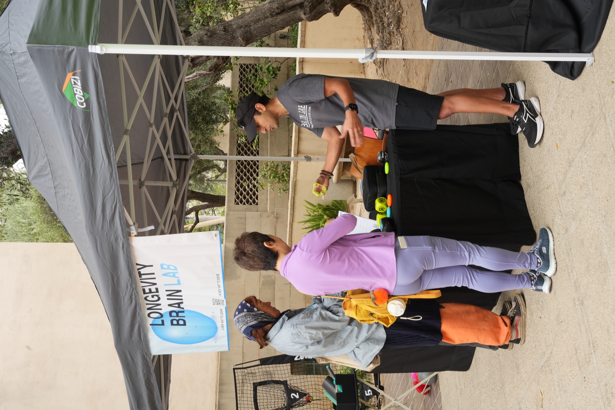 Hackathon participants visiting the Longevity Brain Lab booth
