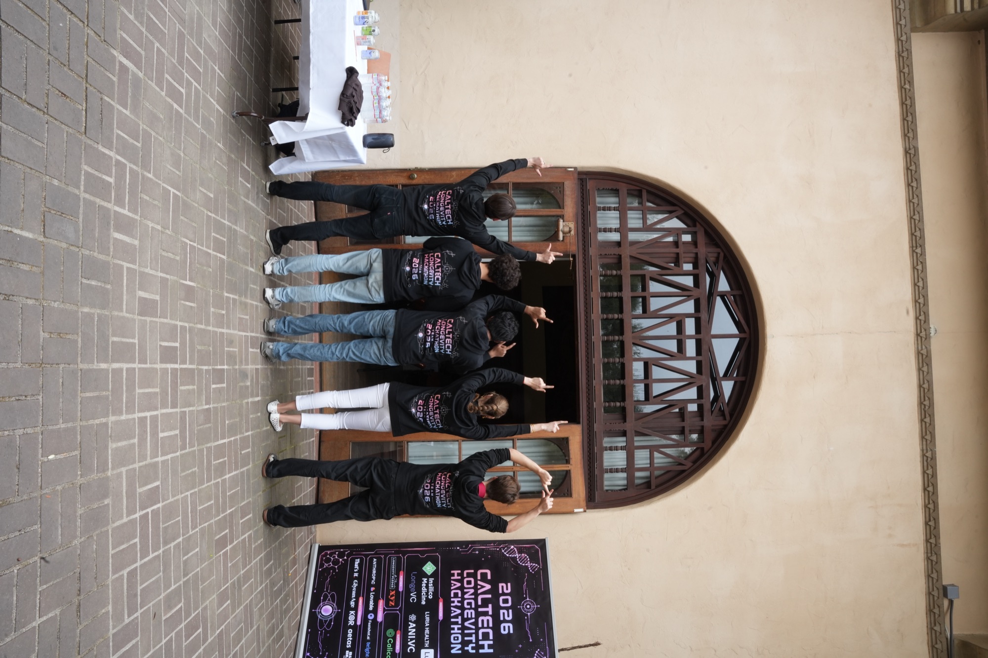 Volunteer team gathered by the hackathon backdrop