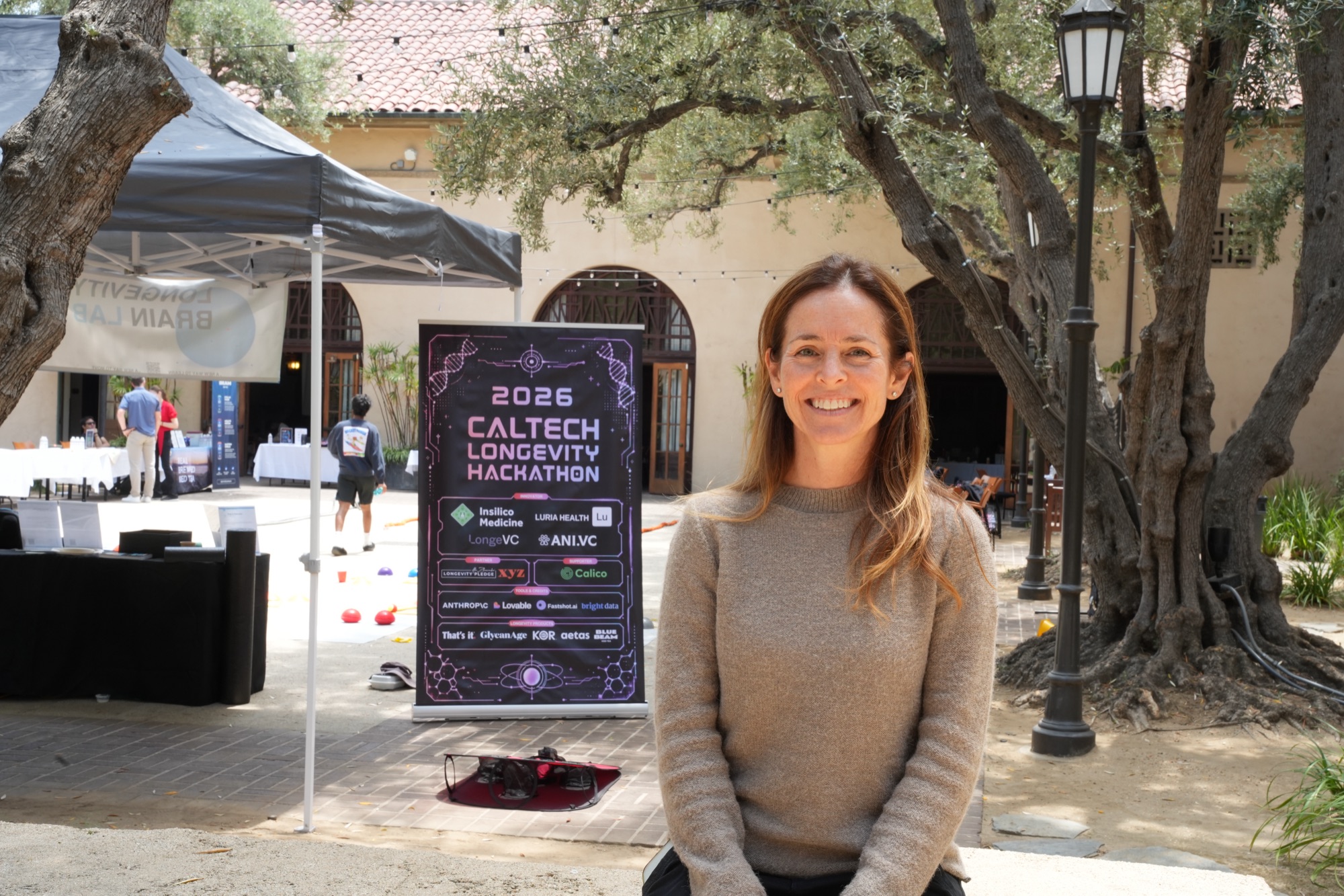 Caltech Longevity Club founder Andrea Olsen at the 2026 hackathon backdrop