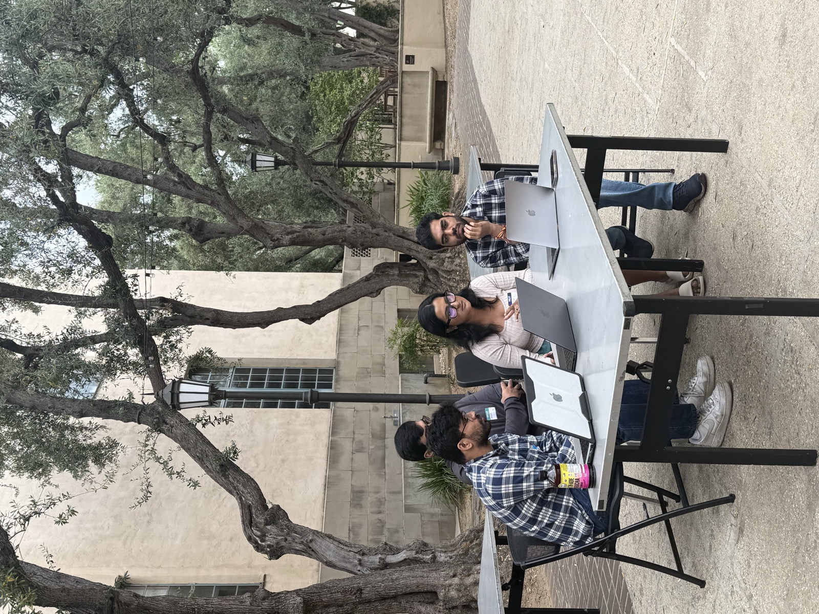 Hackathon participants working outdoors on campus