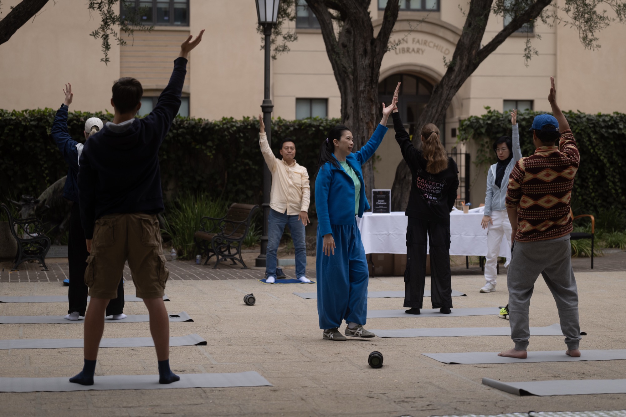 Group practicing under Wen Chen's guidance in the courtyard